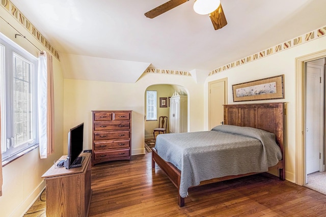 927 Kensington Ave, Flint, MI 48503 - bedroom featuring arched walkways, a ceiling fan, and wood finished floors