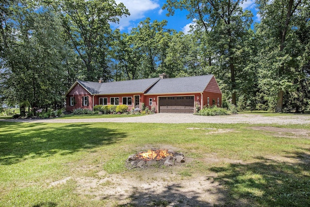 14814 Stone Jug Rd, Battle Creek, MI 49015 - view of front of property featuring a garage, driveway, a front lawn, a chimney, and an outdoor fire pit
