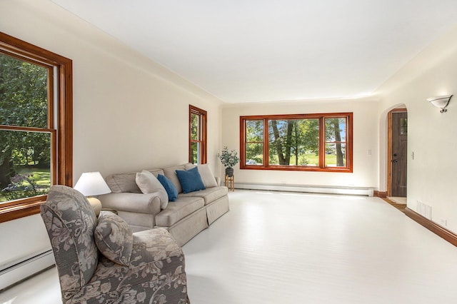 14814 Stone Jug Rd, Battle Creek, MI 49015 - living room with baseboard heating, arched walkways, and plenty of natural light