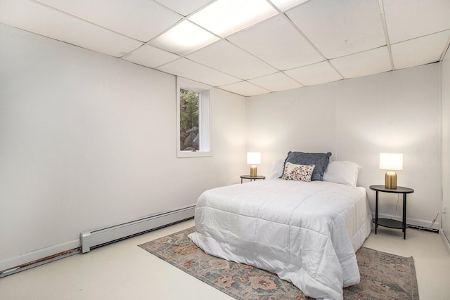 14814 Stone Jug Rd, Battle Creek, MI 49015 - bedroom featuring a baseboard heating unit, a drop ceiling, and finished concrete floors