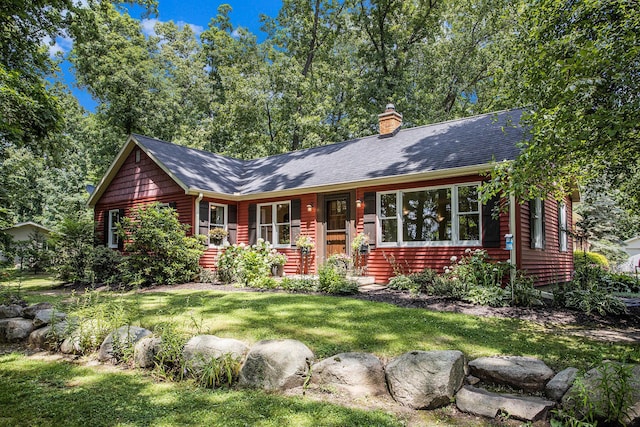 14814 Stone Jug Rd, Battle Creek, MI 49015 - view of front of house featuring a chimney, a front yard, and a shingled roof