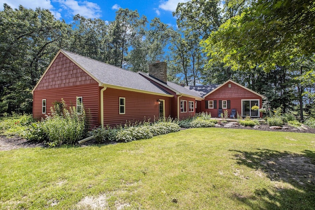 14814 Stone Jug Rd, Battle Creek, MI 49015 - back of property featuring a lawn, a chimney, and a shingled roof