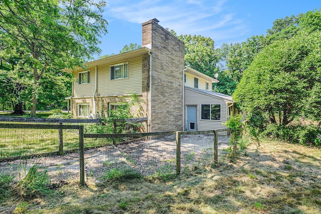 8257 S 2nd St, Michigan, MI 49071 - view of home's exterior with a chimney and brick siding
