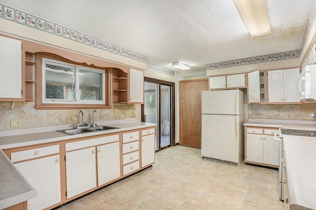 8257 S 2nd St, Michigan, MI 49071 - kitchen featuring white appliances, open shelves, light countertops, a textured ceiling, and white cabinets