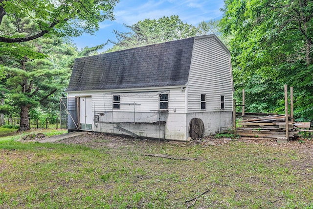 8257 S 2nd St, Michigan, MI 49071 - rear view of house featuring a gambrel roof, roof with shingles, and an outdoor structure