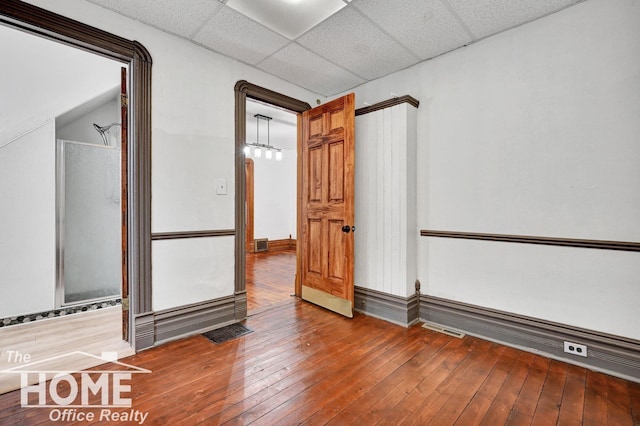 1114 Lynn St, Owosso, MI 48867 - unfurnished room with hardwood / wood-style flooring and a paneled ceiling