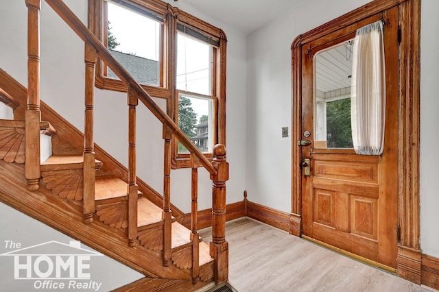 1114 Lynn St, Owosso, MI 48867 - foyer entrance with wood finished floors and stairway