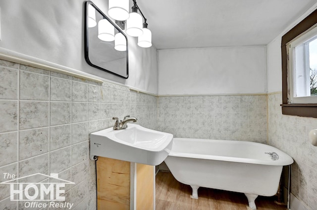 1114 Lynn St, Owosso, MI 48867 - full bathroom with tile walls, a freestanding tub, and wood finished floors