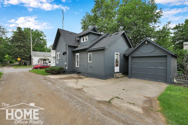 1114 Lynn St, Owosso, MI 48867 - view of front of property with concrete driveway, roof with shingles, an outbuilding, entry steps, and a garage