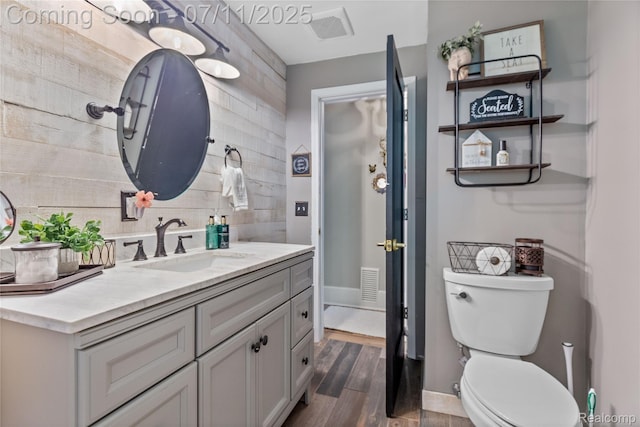 1300 N Livernois Rd, Rochester Hills, MI 48306 - bathroom with vanity, wood finished floors, and backsplash