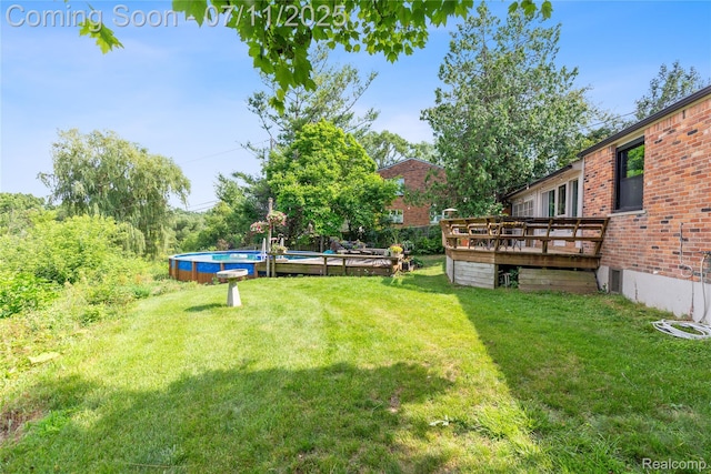 1300 N Livernois Rd, Rochester Hills, MI 48306 - view of grassy yard with a wooden deck and an outdoor pool