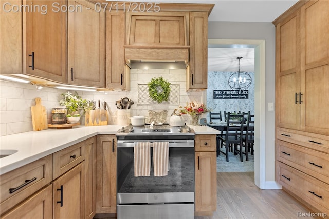 1300 N Livernois Rd, Rochester Hills, MI 48306 - kitchen featuring stainless steel electric range oven, tasteful backsplash, light wood-style flooring, and a chandelier