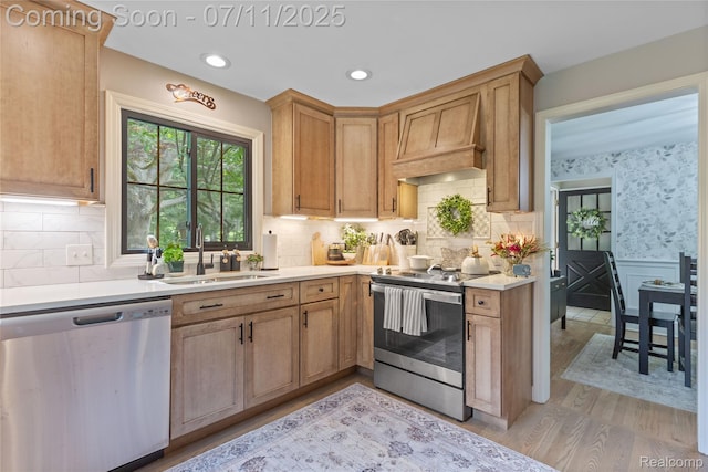 1300 N Livernois Rd, Rochester Hills, MI 48306 - kitchen with appliances with stainless steel finishes, custom exhaust hood, wainscoting, light countertops, and light wood-style flooring