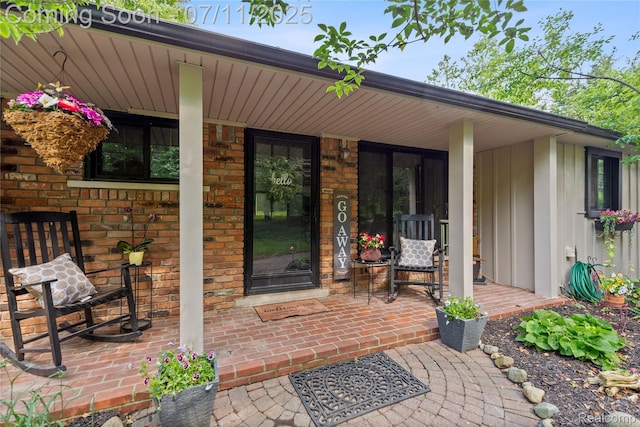 1300 N Livernois Rd, Rochester Hills, MI 48306 - doorway to property featuring a porch, brick siding, and board and batten siding