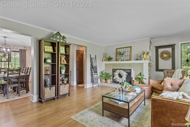 1300 N Livernois Rd, Rochester Hills, MI 48306 - living area with healthy amount of natural light, a chandelier, light wood-type flooring, crown molding, and a fireplace