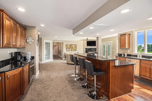 9991 Kaiser Rd, Saline, MI 48176 - kitchen with appliances with stainless steel finishes, open floor plan, a kitchen island, recessed lighting, and a breakfast bar