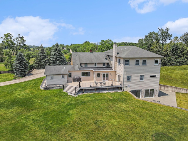 9991 Kaiser Rd, Saline, MI 48176 - rear view of house with a yard, a chimney, and a deck