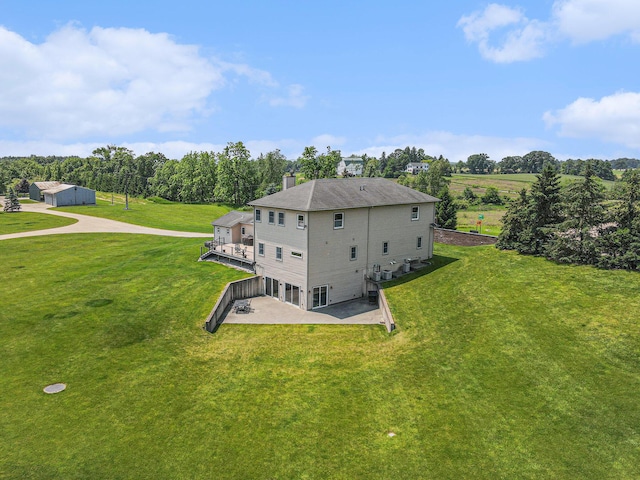 9991 Kaiser Rd, Saline, MI 48176 - rear view of property featuring a chimney, a patio, a yard, and view of wooded area