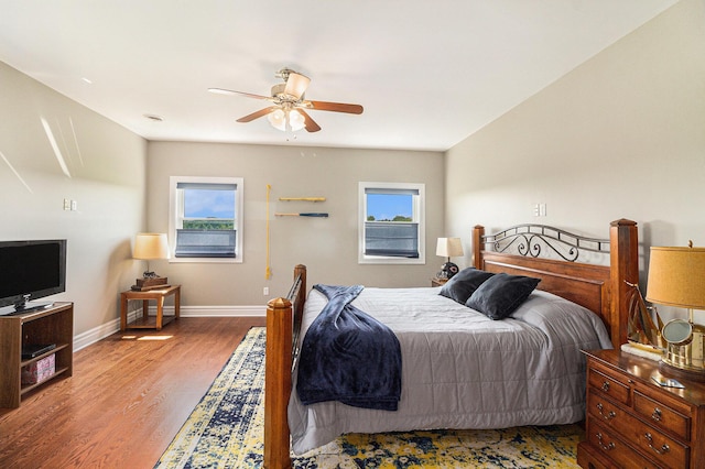 9991 Kaiser Rd, Saline, MI 48176 - bedroom with multiple windows, wood finished floors, and ceiling fan