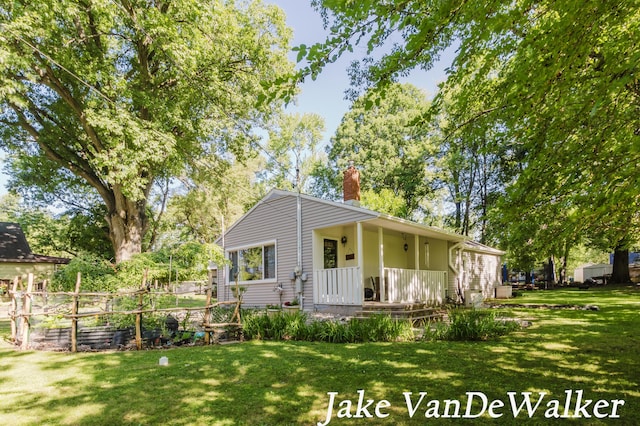 2338 Edgewood Dr, Kalamazoo, MI 49008 - view of front of house with a front lawn and a chimney
