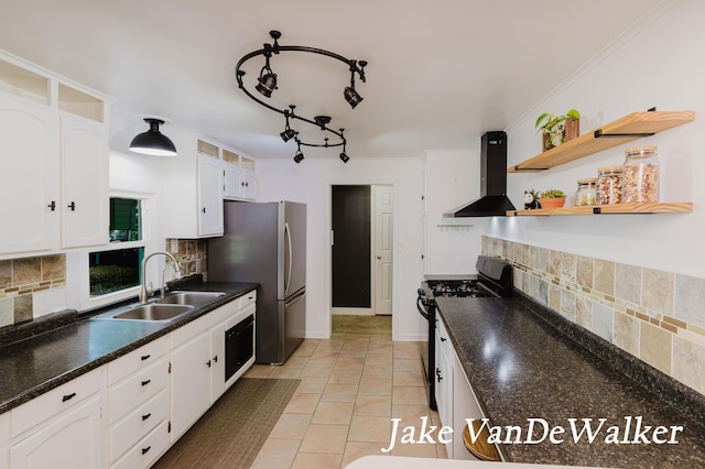 2338 Edgewood Dr, Kalamazoo, MI 49008 - kitchen with gas stove, wall chimney exhaust hood, white cabinetry, and tasteful backsplash