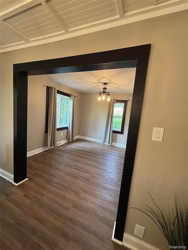 1295 S M 33, West Branch, MI 48661 - spare room featuring dark wood finished floors, a chandelier, and beamed ceiling