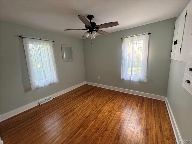 1295 S M 33, West Branch, MI 48661 - spare room featuring healthy amount of natural light, wood finished floors, and a ceiling fan