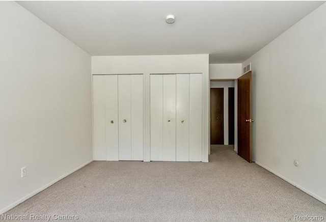 30260 Southfield Rd, Southfield, MI 48076 - unfurnished bedroom featuring two closets and carpet flooring