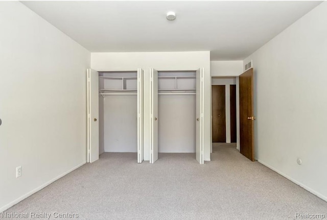 30260 Southfield Rd, Southfield, MI 48076 - unfurnished bedroom featuring multiple closets and carpet floors