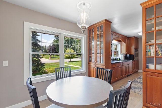 144 N Scott St, Adrian, MI 49221 - dining area with light wood finished floors and arched walkways
