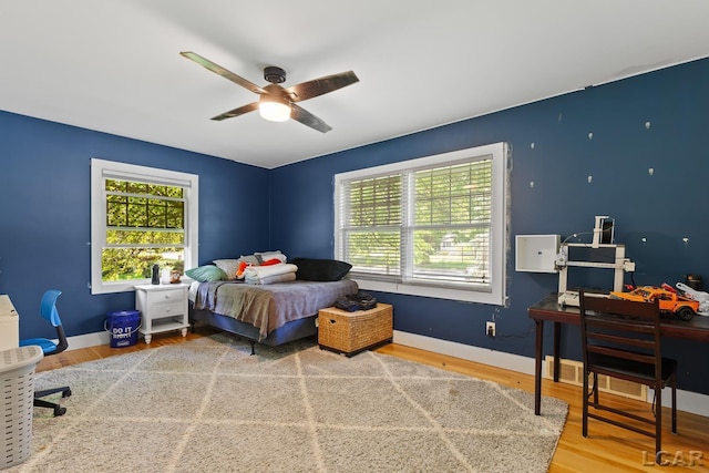144 N Scott St, Adrian, MI 49221 - bedroom with wood finished floors, a desk, and a ceiling fan