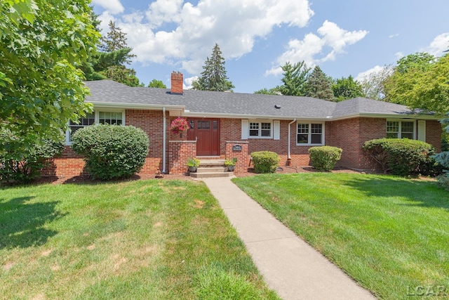 144 N Scott St, Adrian, MI 49221 - ranch-style home with a chimney, brick siding, and a front yard