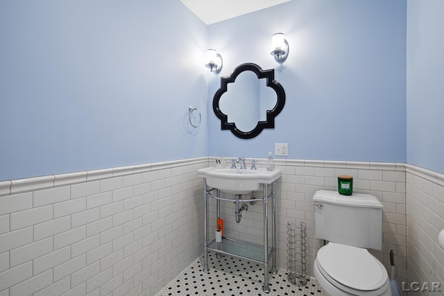 144 N Scott St, Adrian, MI 49221 - bathroom featuring wainscoting and tile walls