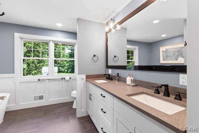 144 N Scott St, Adrian, MI 49221 - bathroom featuring double vanity, recessed lighting, and a freestanding bath