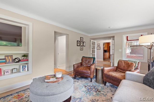 144 N Scott St, Adrian, MI 49221 - living room featuring wood finished floors and baseboards