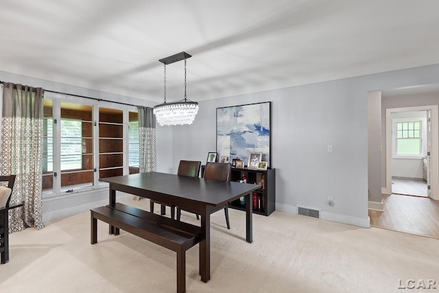144 N Scott St, Adrian, MI 49221 - dining space with light carpet and a chandelier