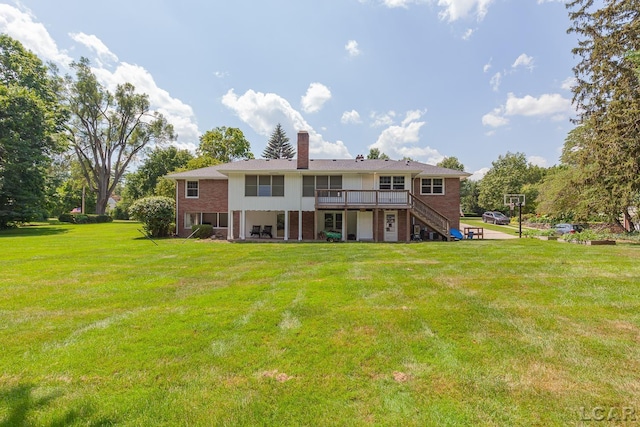 144 N Scott St, Adrian, MI 49221 - rear view of house featuring stairs, brick siding, a deck, a yard, and a chimney