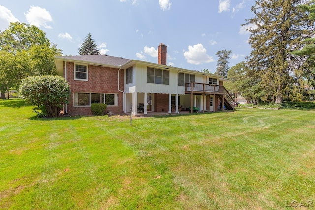 144 N Scott St, Adrian, MI 49221 - rear view of property featuring a chimney, stairs, a deck, brick siding, and a yard