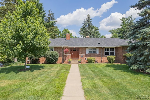 144 N Scott St, Adrian, MI 49221 - ranch-style home with a chimney, a front yard, brick siding, and roof with shingles