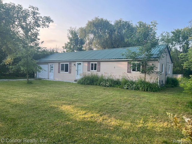 5035 Burma Rd, Kimball, MI 48074 - ranch-style home with a front yard, a metal roof, and an attached garage