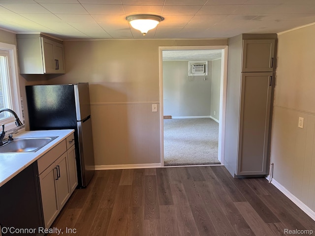 5035 Burma Rd, Kimball, MI 48074 - kitchen with freestanding refrigerator, dark wood-type flooring, light countertops, a wall mounted air conditioner, and a wainscoted wall