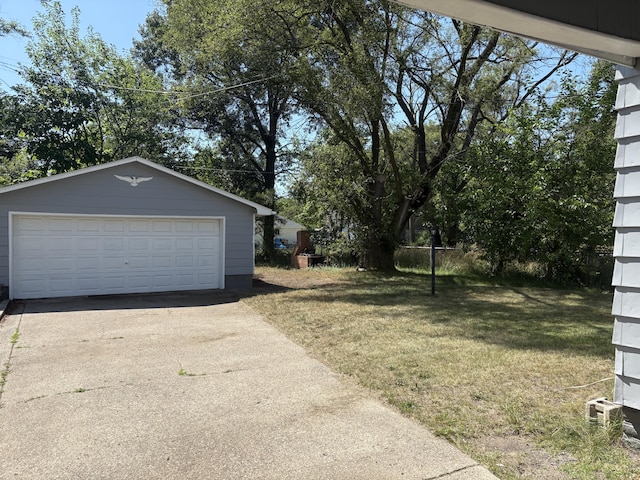 2233 Mc Ilwraith St, Muskegon Heights, MI 49444 - view of grassy yard featuring an outdoor structure and a detached garage