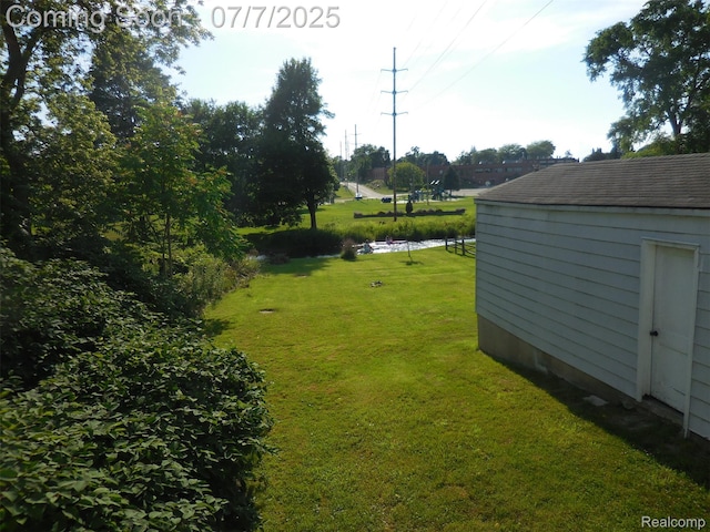 501 N Leroy St, Fenton, MI 48430 - view of green lawn featuring a storage shed