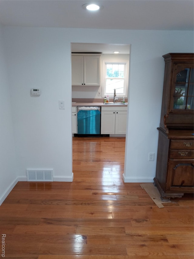501 N Leroy St, Fenton, MI 48430 - kitchen with dishwasher, white cabinetry, light wood finished floors, recessed lighting, and light countertops