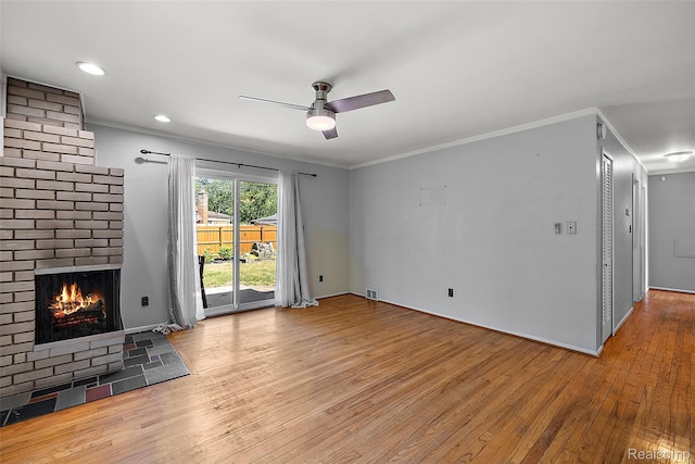 26250 Virginia Dr, Warren, MI 48091 - unfurnished living room featuring light wood-type flooring, ceiling fan, a brick fireplace, and ornamental molding