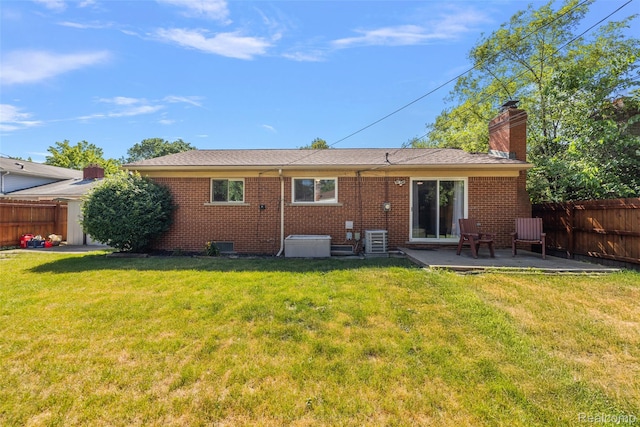 26250 Virginia Dr, Warren, MI 48091 - rear view of house with a chimney, a patio area, and brick siding