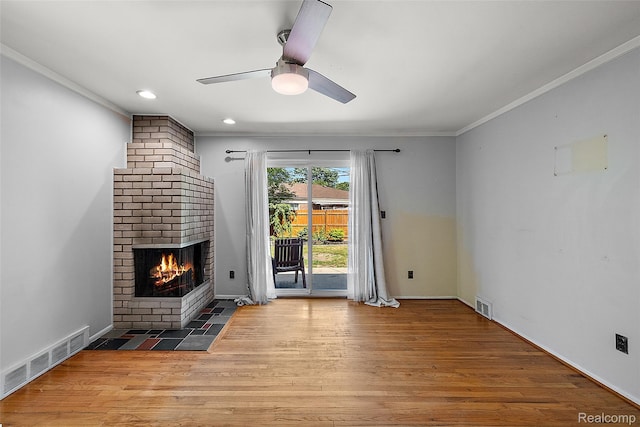 26250 Virginia Dr, Warren, MI 48091 - unfurnished living room featuring a brick fireplace, wood finished floors, crown molding, a ceiling fan, and recessed lighting