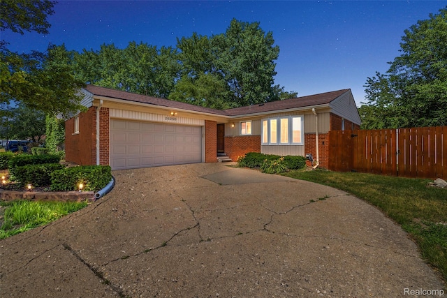 26250 Virginia Dr, Warren, MI 48091 - view of front facade featuring brick siding, a garage, and driveway