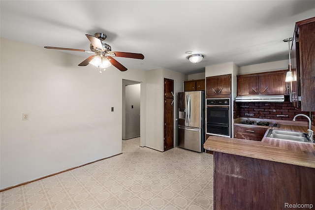 26250 Virginia Dr, Warren, MI 48091 - kitchen featuring stainless steel fridge, oven, light flooring, dark brown cabinets, and range hood