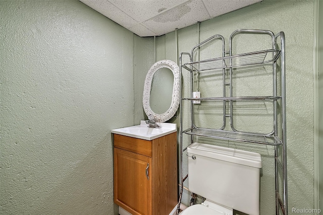 26250 Virginia Dr, Warren, MI 48091 - half bathroom featuring a drop ceiling, a textured wall, and vanity